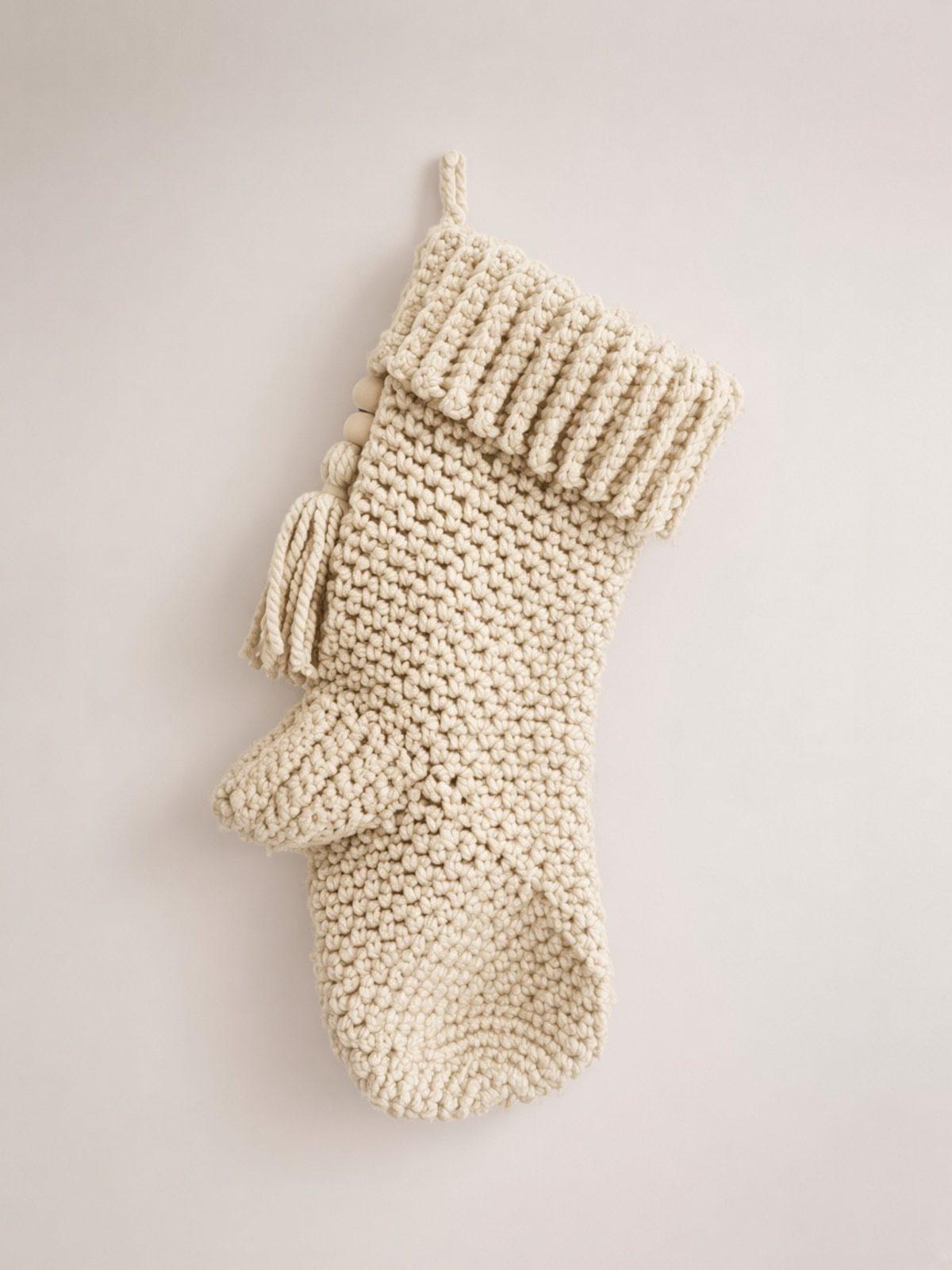 Cream crochet Christmas stocking with ribbed cuff and tassel