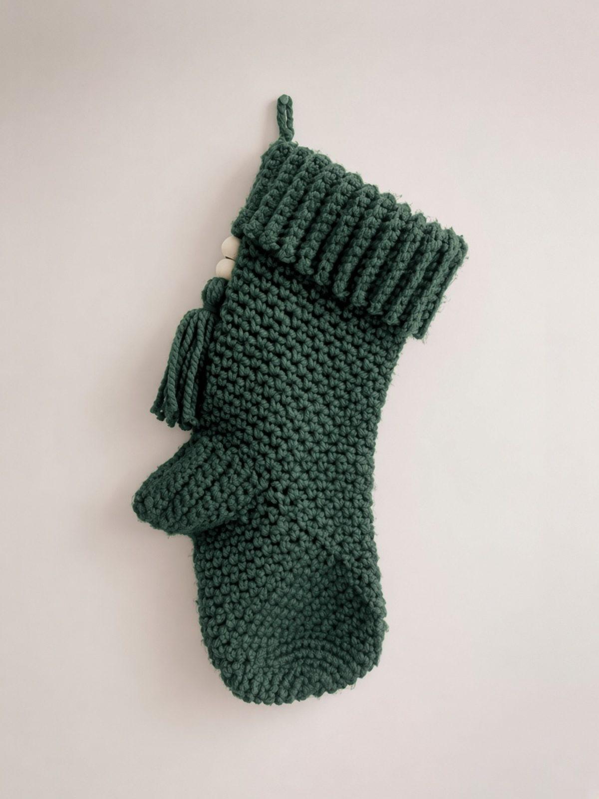 Pine green crochet Christmas stocking with ribbed cuff and tassel